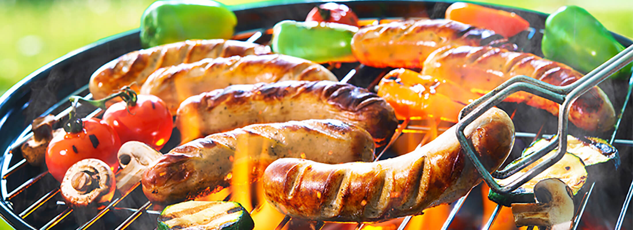 Gluten-free sausages with vegetables on a barbecue